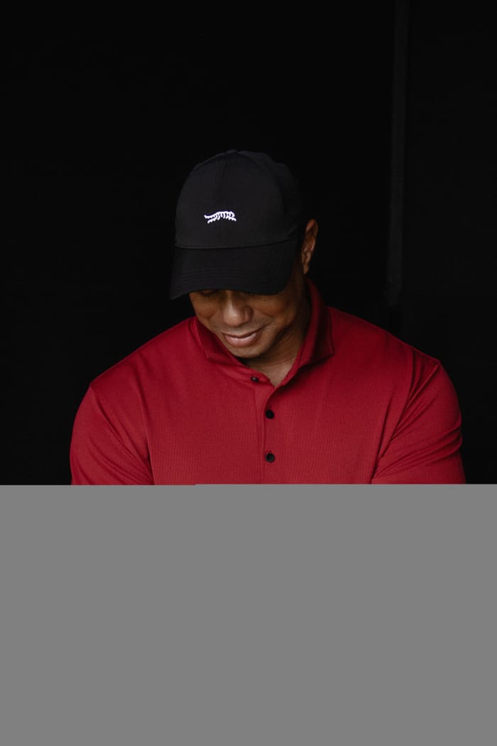 Tiger Woods models a red Sun Day Red shirt.